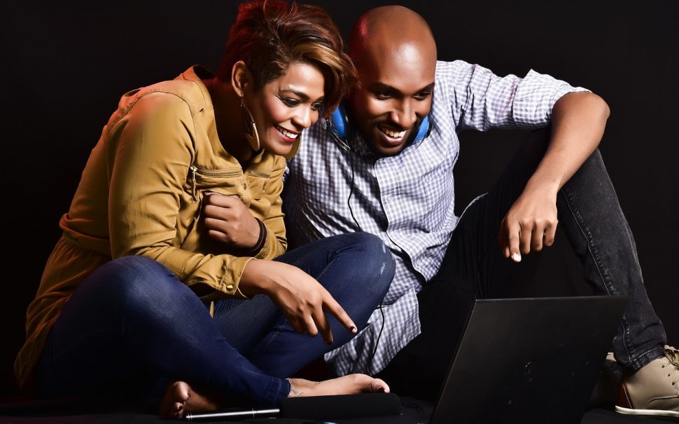 Couple watching TV on their laptop