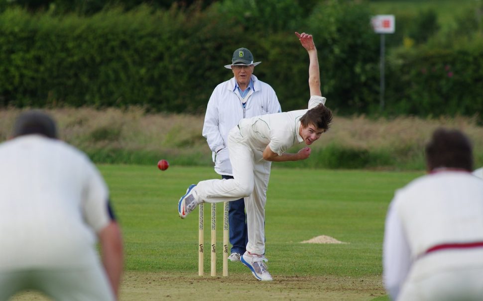 Person running in to bowl a cricket ball