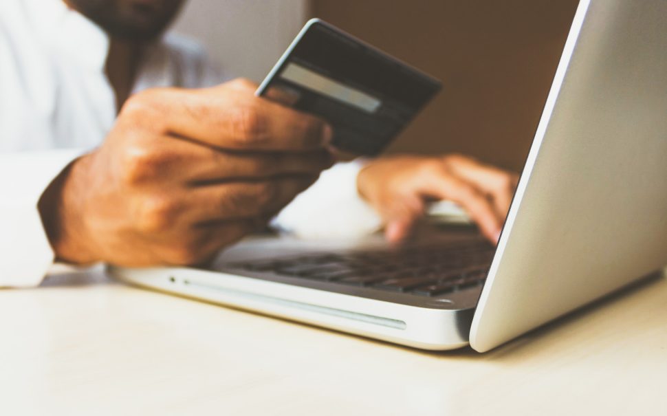 Person sat at laptop with credit card