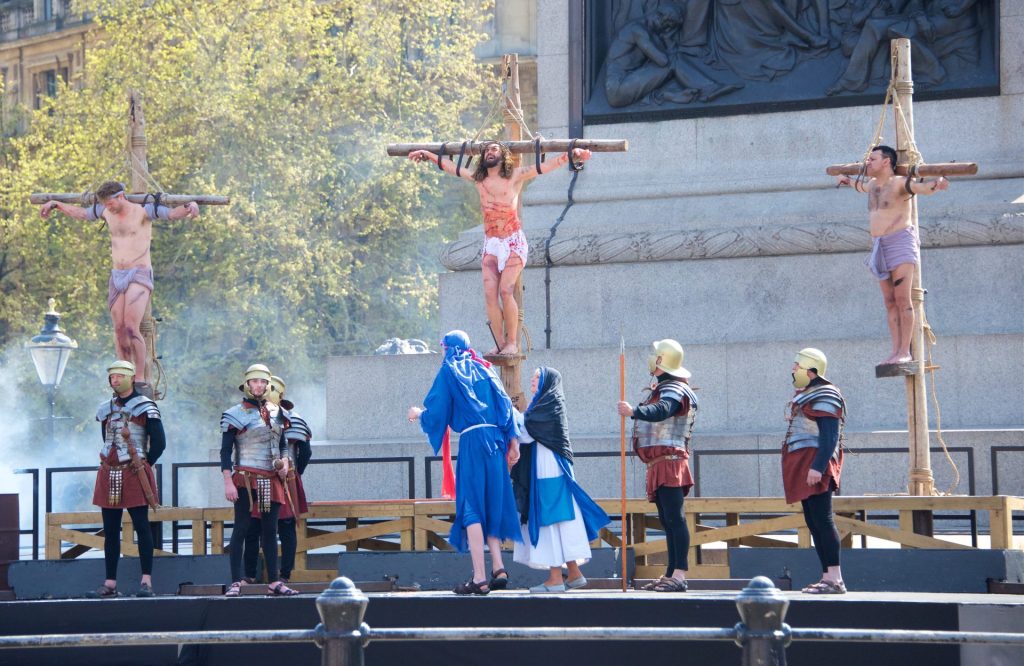 Scene of Jesus' crucifixion in Trafalgar Square with Roman soldiers underneath