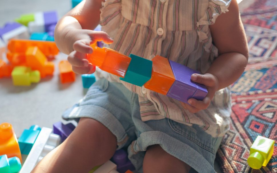 Stock image of child playing with building blocks