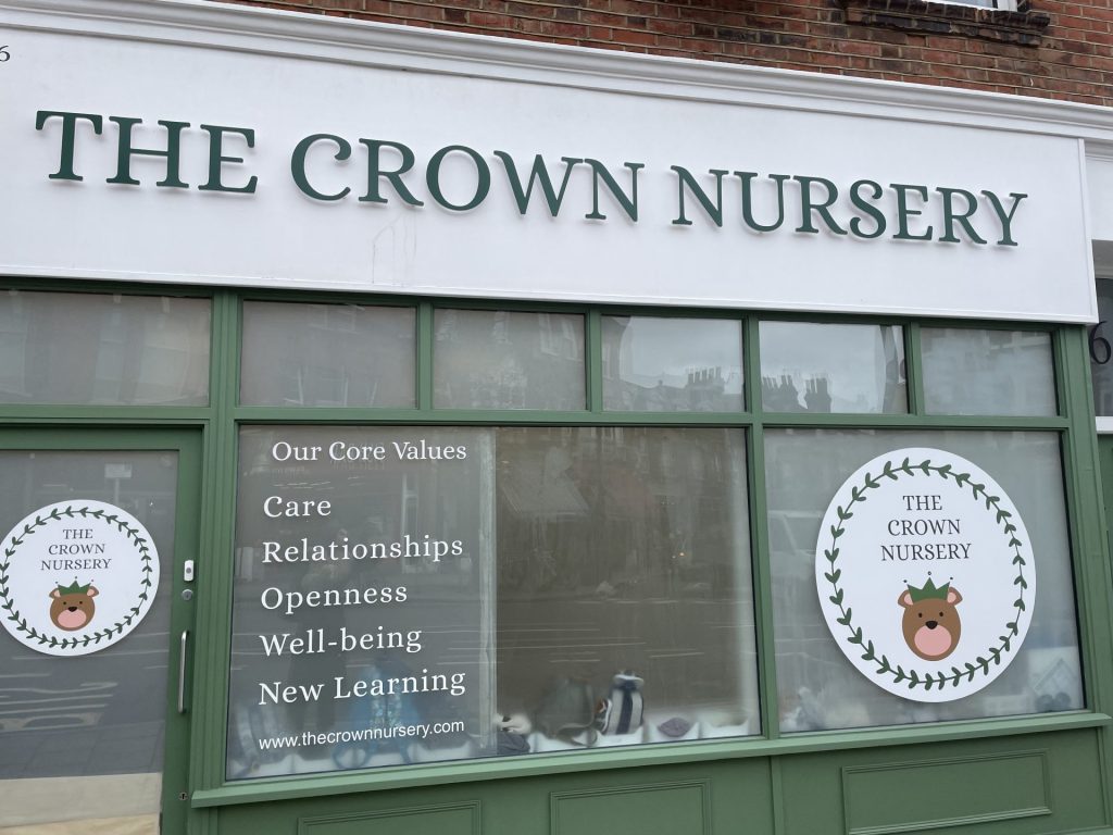 photo of the frontage for the Crown Nursery which dictates their core values of care, relationships, openness, well-being and new learning 