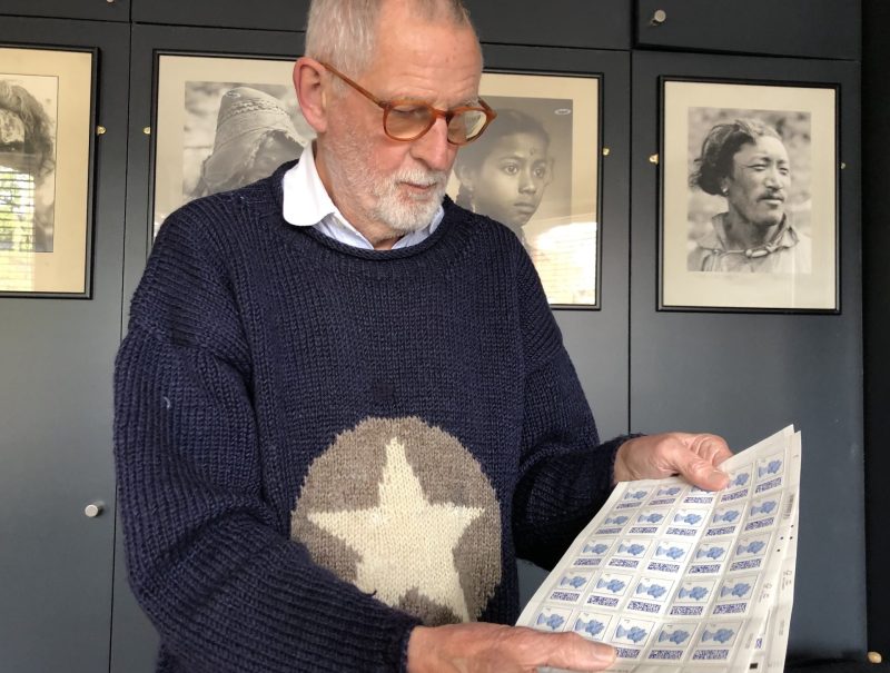 Tony Rushton looking at his sheets of one pence stamps