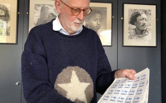 Tony Rushton looking at his sheets of one pence stamps