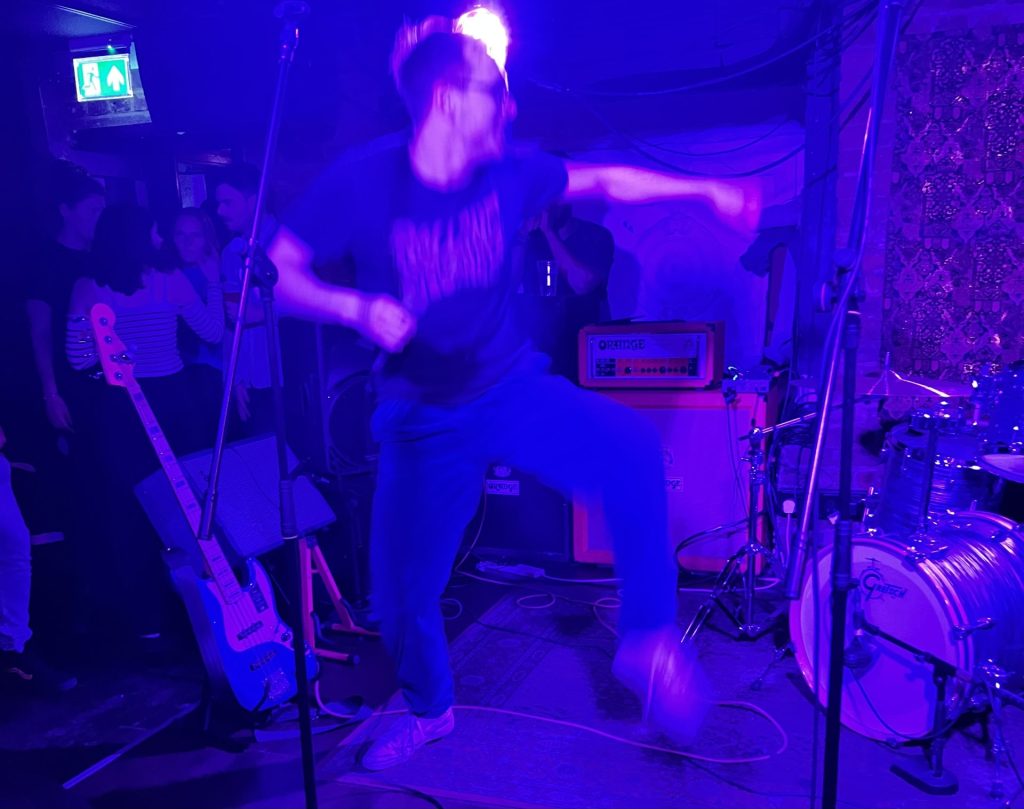 A band member jumping on stage