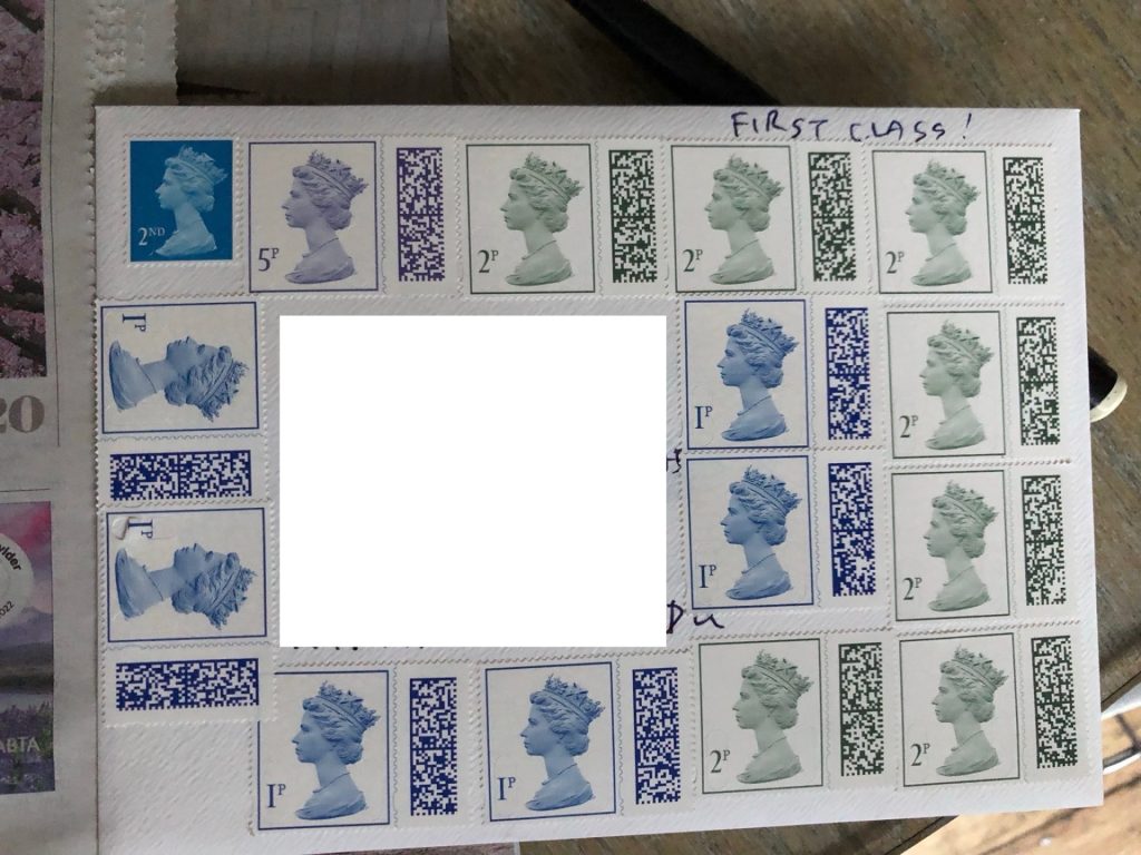 An envelope showing one and two pence stamps covering the entirety of the envelope 