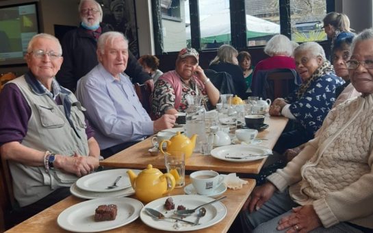 people sat in a pub eating lunch