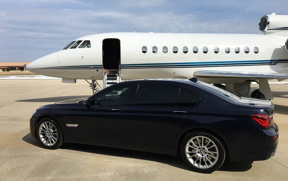 A private jet with a car parked in front