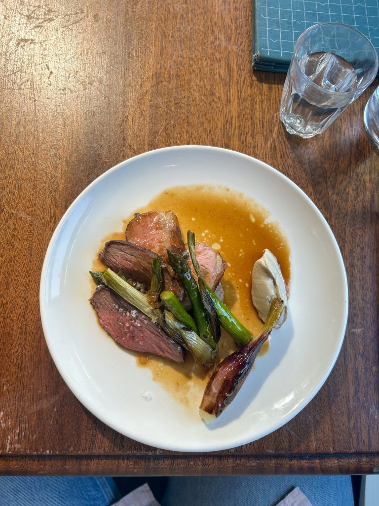 A plate of food with mutton, onions and anchovy to show the food at Marksman