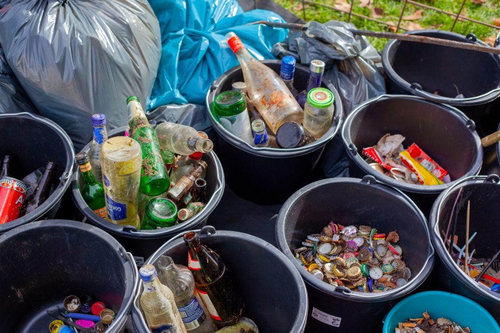 Bottles and bottle tops separated into separate containers to recycle