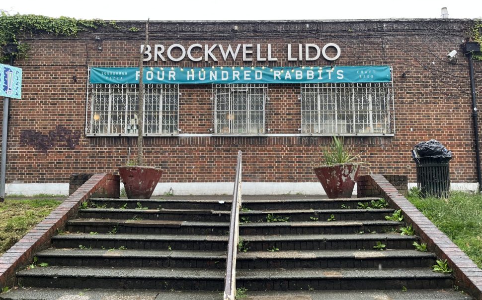 Steps leading up to a red brick building with a sign reading 'Brockwell Lido'