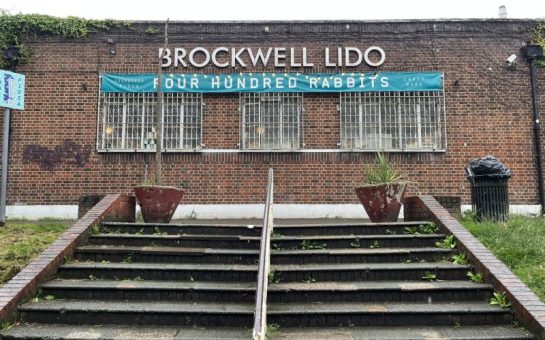 Steps leading up to a red brick building with a sign reading 'Brockwell Lido'