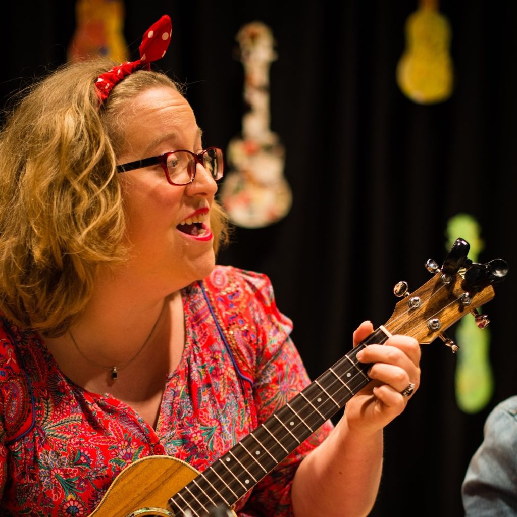 Founder Tara singing and playing the ukulele at a children's festival organised by the London Ukulele Project in Richmond.