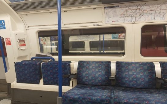 A photo of a empty tube car at night