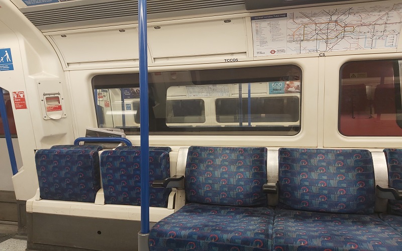 A photo of a empty tube car at night