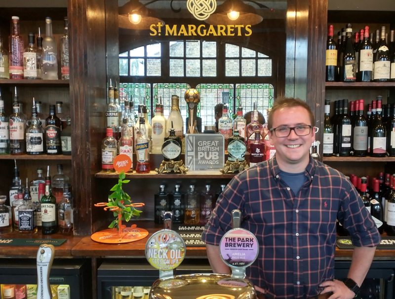 Manager, Ollie Coulombeau, behind bar with trophy