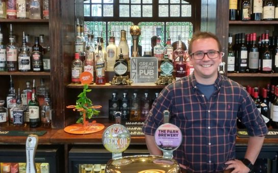 Manager, Ollie Coulombeau, behind bar with trophy