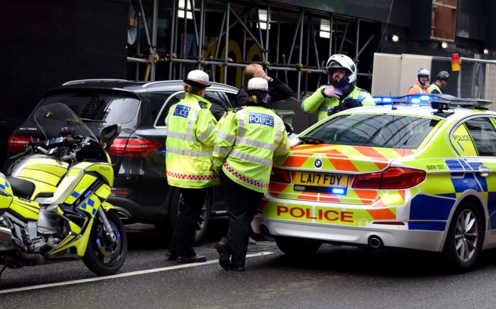 Police cars and officers surrounding a scene