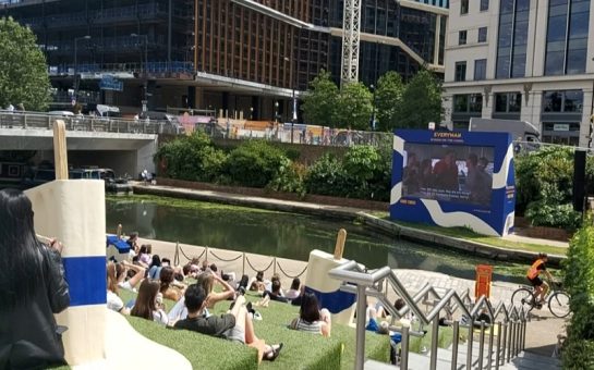 Photo of people watching the screen at the open air cinema in Kings Cross