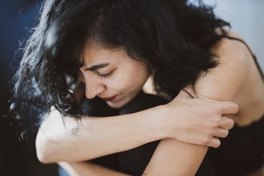 Woman looking sad with her head in her hands