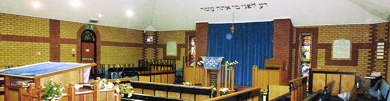 The interior of Richmond Synagogue. Contains pews and a "Bimah" (an alter)