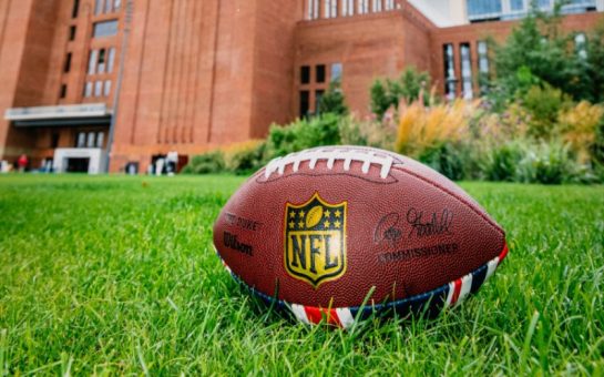 A NFL American Football on the grass outside of Battersea Power station for the NFL Experience London