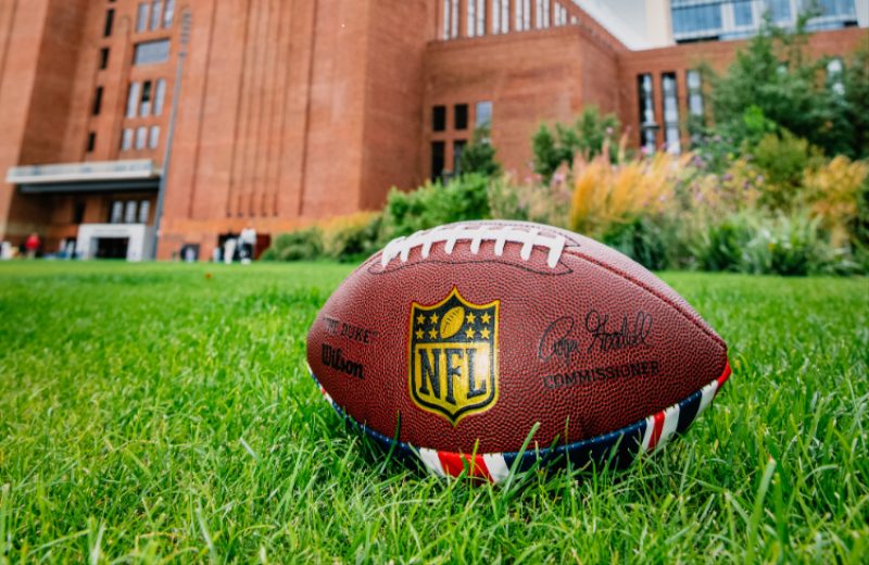 A NFL American Football on the grass outside of Battersea Power station for the NFL Experience London