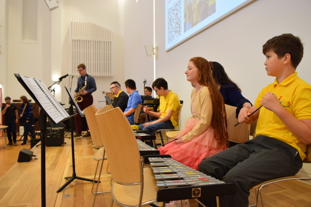 Members of the OK Music School Band on-stage.