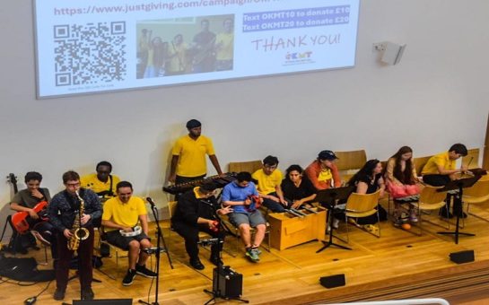 Members of the OK Music School band performing on-stage in a Richmond church