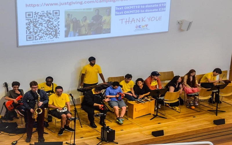 Members of the OK Music School band performing on-stage in a Richmond church