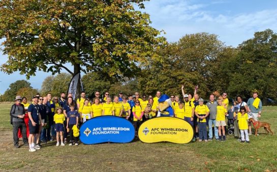 A group of fundraisers pose for a photo at the start of their walk