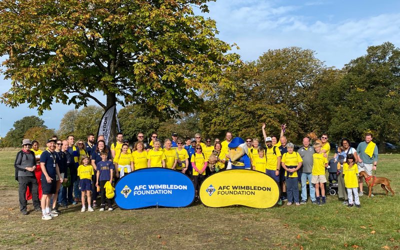 A group of fundraisers pose for a photo at the start of their walk