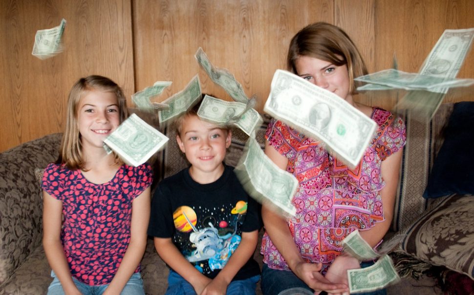 Money raining down on happy children