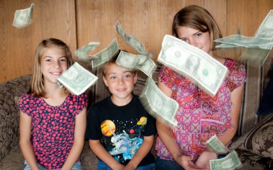 Money raining down on happy children