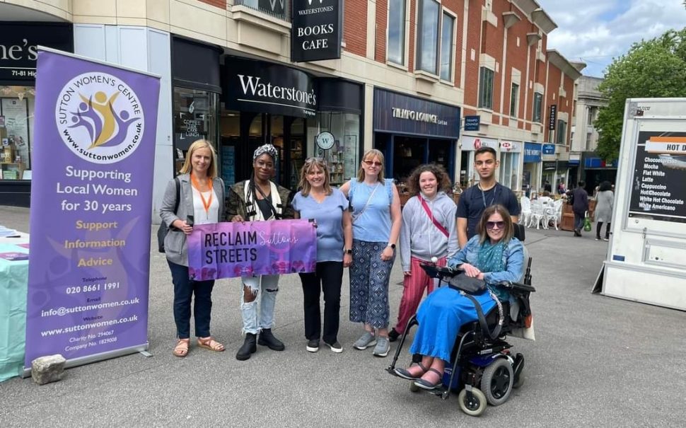 Sutton Women's Centre supporters hold up banner saying "Reclaim Sutton's streets"