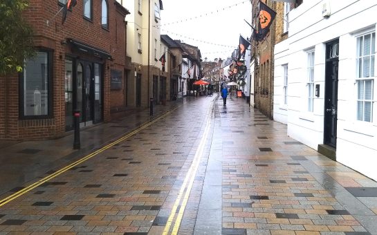 Church Street, with shops either side, lacking shoppers due to the rain.