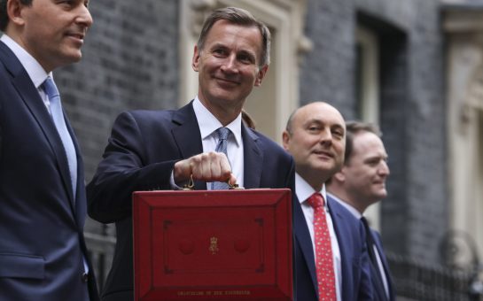 Chancellor of the Exchequer Jeremy Hunt on Budget Day holding a red briefcase to the camera