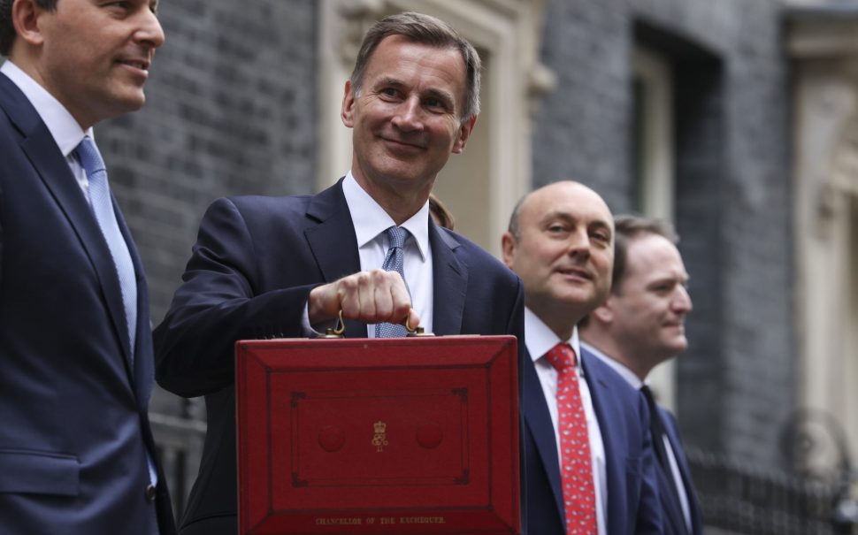 Chancellor of the Exchequer Jeremy Hunt on Budget Day holding a red briefcase to the camera