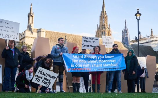 Campaigners from the Smart Motorways Kill campaign stand outside Birmingham International Convention Centre in protest