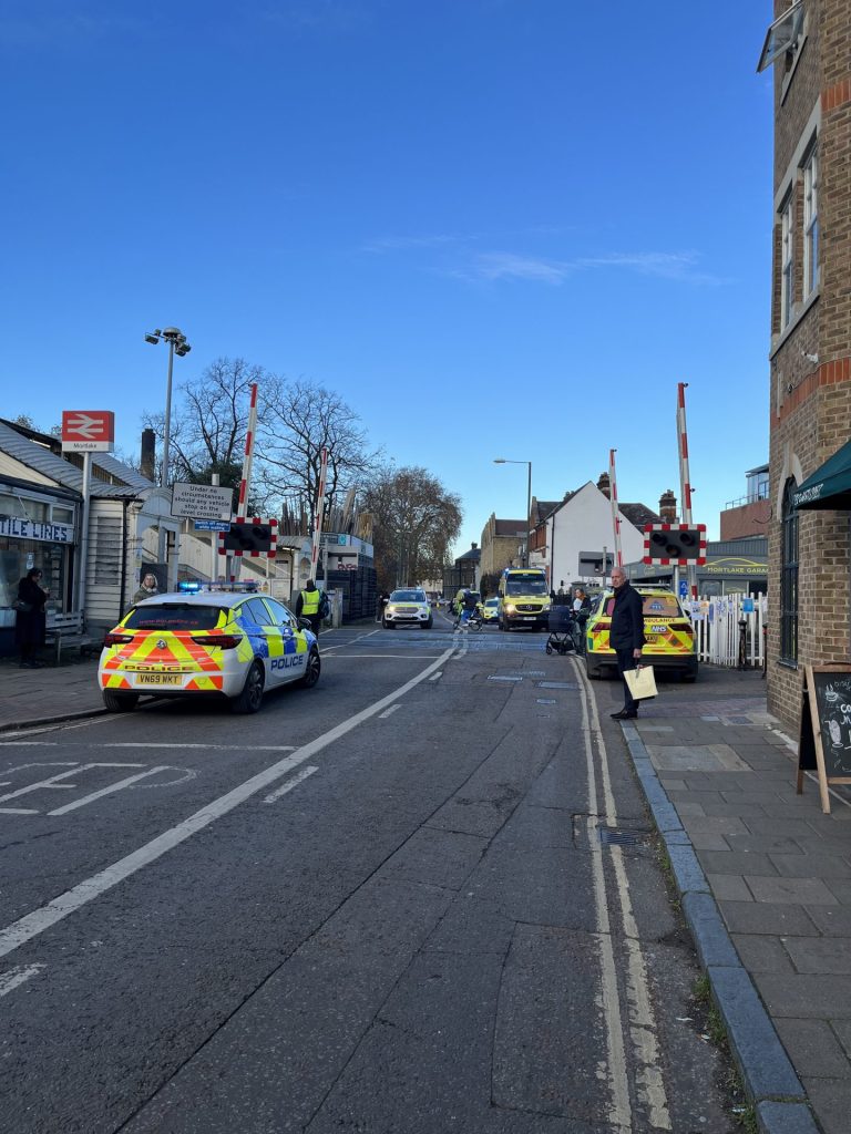 Police cars parked outside Mortlake train station in south-west London