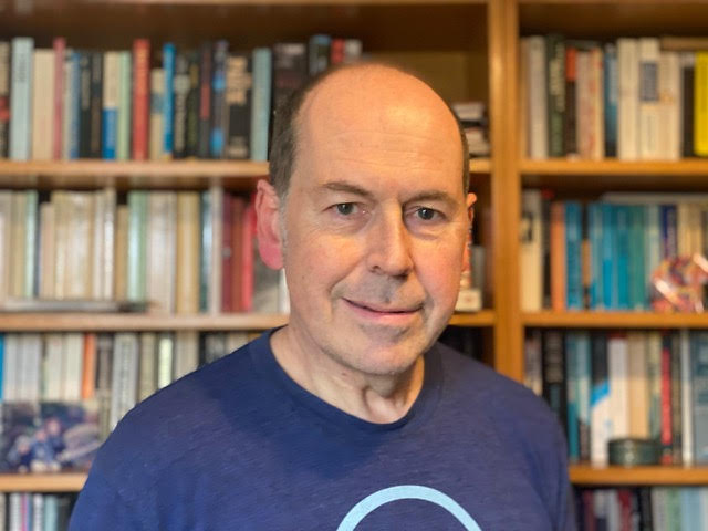 Image of author and former BBC journalist Rory Cellan-Jones standing in front of a bookshelf.
