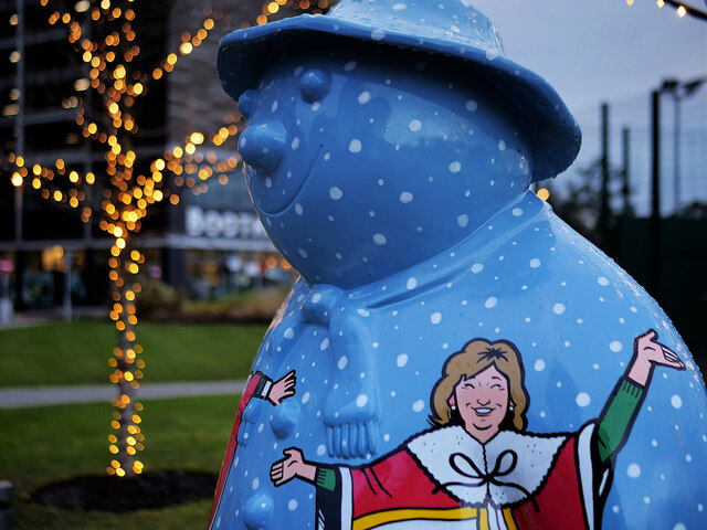 A snowman statue painted blue with white snow marks