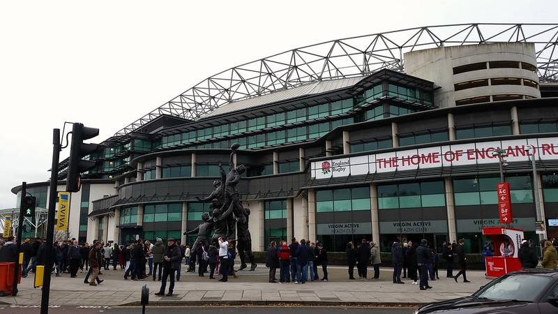 Photo outside twickenham stadium with the banner "home of rugby".