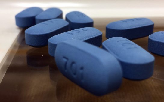 Image of PrEP pills. They are dark blue and have the number 701 etched onto them.