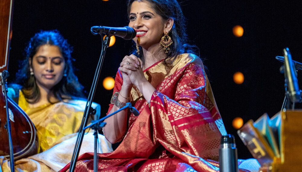 Person sitting on the floor in front of a mic