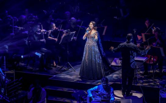 Woman in lehenga singing on stage