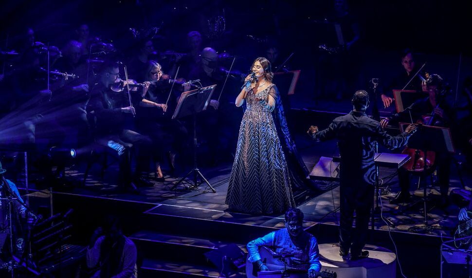 Woman in lehenga singing on stage