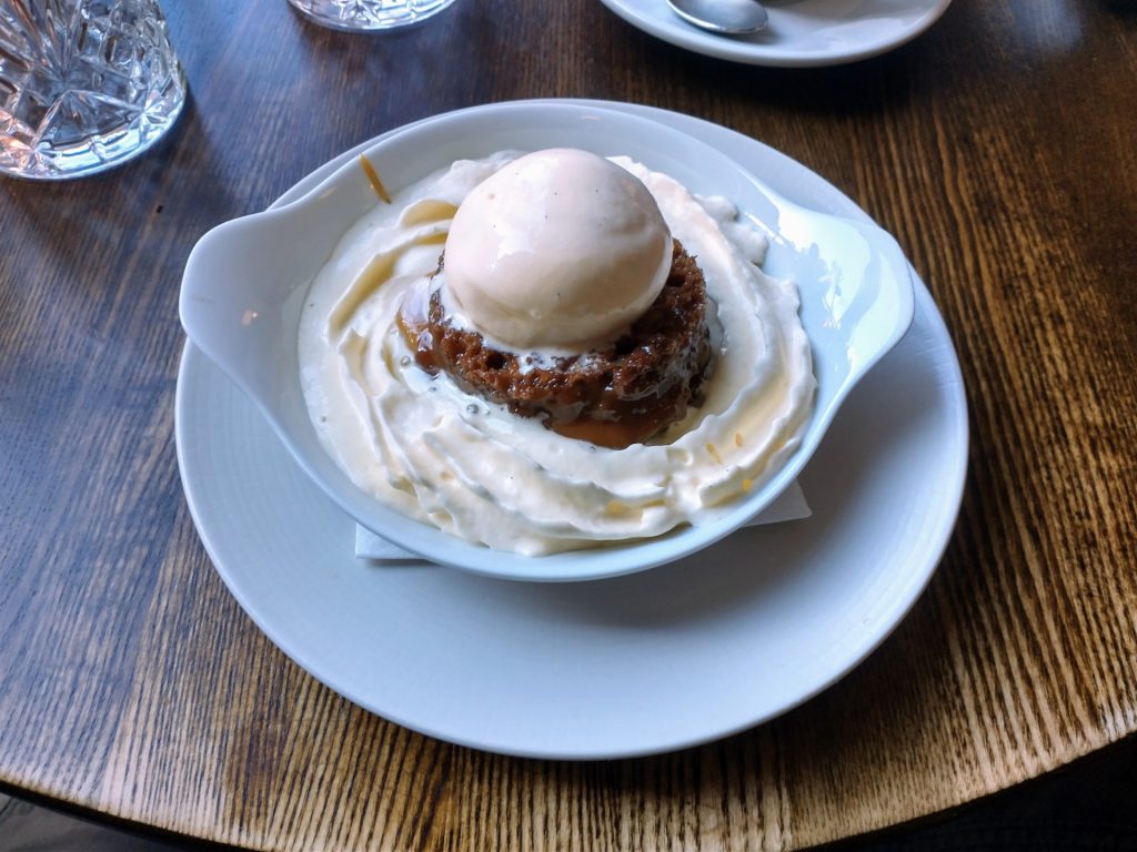 Sticky toffee pudding with cream and ice cream