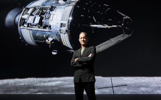 American actor Tom Hanks stands in front of a screen of a rocket launched into space as part of a new immersive experience at the Lightroom in King's Cross