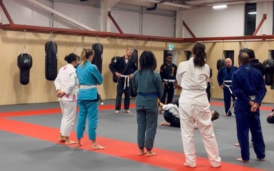 The image shows four women training in Brazilian jiu-jitsu at a martial arts centre in Twickenham.